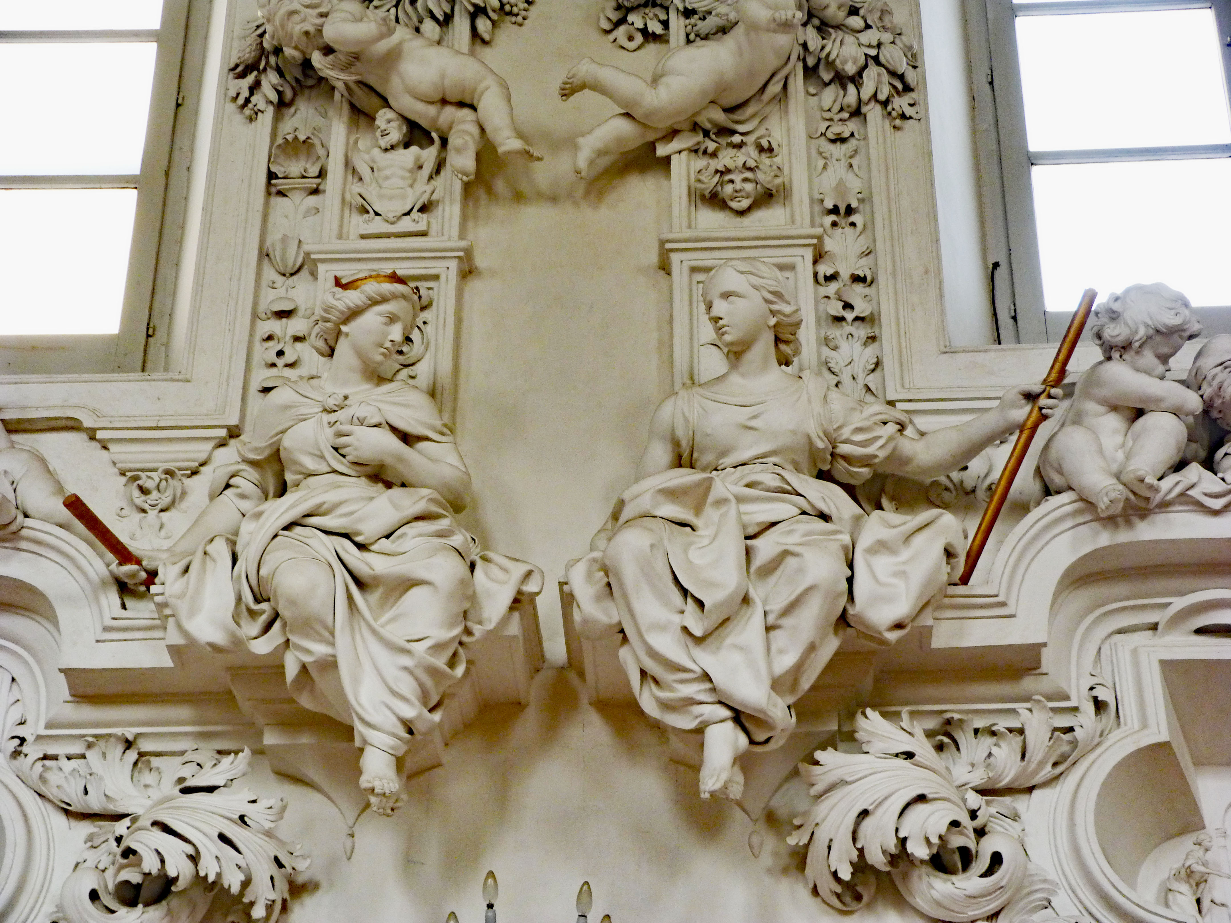 Notice the devil above the statue